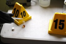 A Beale emergency management technician, from the 9th Civil Engineering Squadron, samples a chemical found at a simulated hazardous scene as part of an exercise on June 10, 2015 at Beale Air Force Base, California. The exercise was part of the Integrated Base Emergency Response Capabilities Training designed to strengthen Airmen’s emergency response skills. (U.S. Air Force photo by Airman Preston L. Cherry/Released)