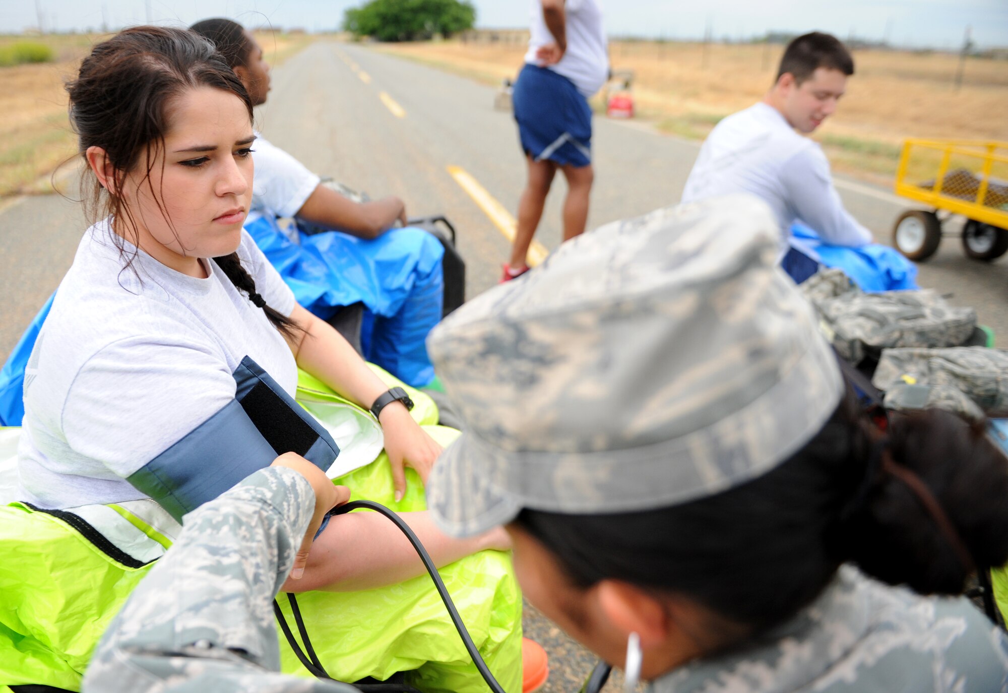 A Beale Airman receives a medical examination during a simulated hazardous scene as part of an exercise on June 10, 2015 at Beale Air Force Base, California. The exercise was part of the Integrated Base Emergency Response Capabilities Training designed to strengthen Airmen’s emergency response skills. (U.S. Air Force photo by Airman Preston L. Cherry/Released)