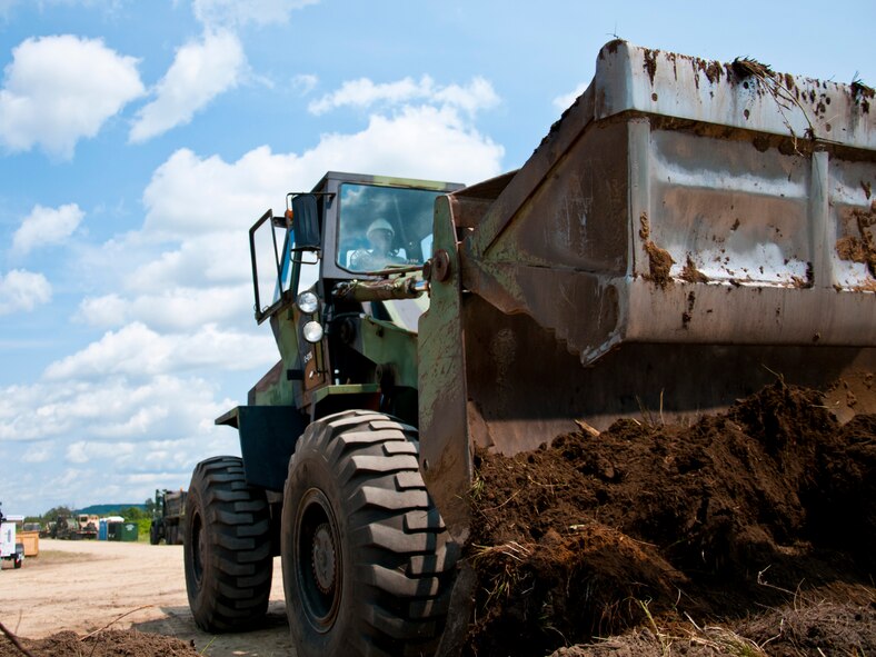 Airman 1st Class Joseph Kamunyu, 446th Civil Engineer Squadron heavy equipment maintainer, fortifies an area for drinking water at Fort McCoy, WI. during Patriot Warrior, June 10th, 2015. Patriot Warrior is the Air Force Reserve Command portion of a much larger joint expeditionary exercise involving almost 6,000 Sailors, Soldiers, Airmen and multinational forces. Formerly known as Global Medic, the exercise still focuses primarily on aeromedical training and readiness, but has evolved over time to become much more multi-faceted. Securing a source of potable drinking water was one of the primary concerns and responsibilities of the 446th CES upon arrival. (U.S. Air Force photo by Senior Airman Daniel Liddicoet/Released)