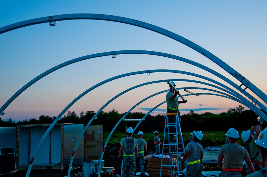 Members of the 446th Civil Engineer Squadron begin building a tent at Fort McCoy, WI. during Patriot Warrior, June 7th, 2015. Patriot Warrior is the Air Force Reserve Command portion of a much larger joint expeditionary exercise involving almost 6,000 Sailors, Soldiers, Airmen and multinational forces. Formerly known as Global Medic, the exercise still focuses primarily on aeromedical training and readiness, but has evolved over time to become much more multi-faceted. Members of the 446th CES began working immediately upon arrival to build tents that they could sleep in for the night. They worked through the night to ensure proper living conditions for their team. (U.S. Air Force photo by Senior Airman Daniel Liddicoet/Released)