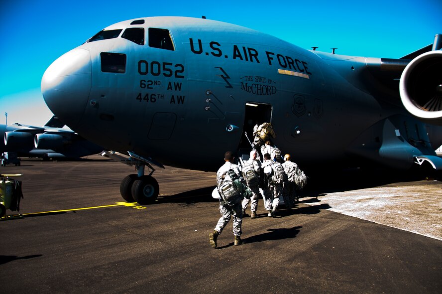 Members of the 446th Civil Engineer Squadron board a C-17 Globemaster as they prepare to fly to Fort McCoy, WI. to participate in Patriot Warrior,  June 7th, 2015. Over the past week, the 446th Civil Engineer Squadron has proudly represented McChord Airfield during the Patriot Warrior exercise currently underway at a satellite location of Fort McCoy. After arriving with their first wave on May 30th, they began a coordinated effort to build a fully sustainable base for exercise participants to live and train on from the ground up. (U.S. Air Force photo by Senior Airman Daniel Liddicoet/Released)