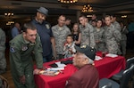 Members of the JBSA-Randolph community listen to Mr. Thomas M. Ellis, documented original Tuskegee Airmen, speak about his time serving with the Tuskegee Airmen during the Tuskegee Airmen Tribute, June 12, 2015, at Joint Base San Antonio-Randolph’s Parr Club.  Members of the JBSA-Randolph community celebrated the legacy of the first all-black unit by paying tribute to seven of the documented original Tuskegee Airmen members.  The Tuskegee Airmen distinguished themselves during World War II with more than 15,500 sorties and 1,500 missions in Europe and North Africa and earned numerous combat awards.  The event featured musical entertainment, comments by 12th Flying Training Wing leaders, an introduction of four Tuskegee Airmen present and a presentation of gifts to them. Members of the audience had an opportunity to mingle with the Tuskegee Airmen and listen to their stories. (U.S. Air Force photo by Johnny Saldivar/released)