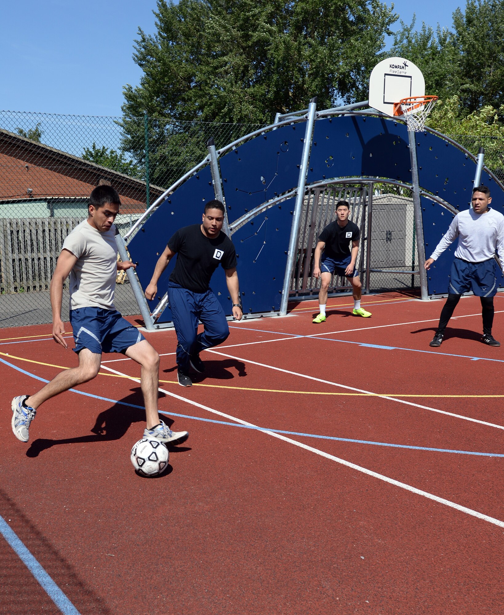 Team Mildenhall Airmen compete in a soccer match during the Marauder Melee event June 11, 2015, on RAF Mildenhall, England. The Marauder Melee is an annual competition featuring several events which promote fitness, friendly competition and camaraderie among various units on base. (U.S. Air Force photo by Senior Airman Kyla Gifford/Released)