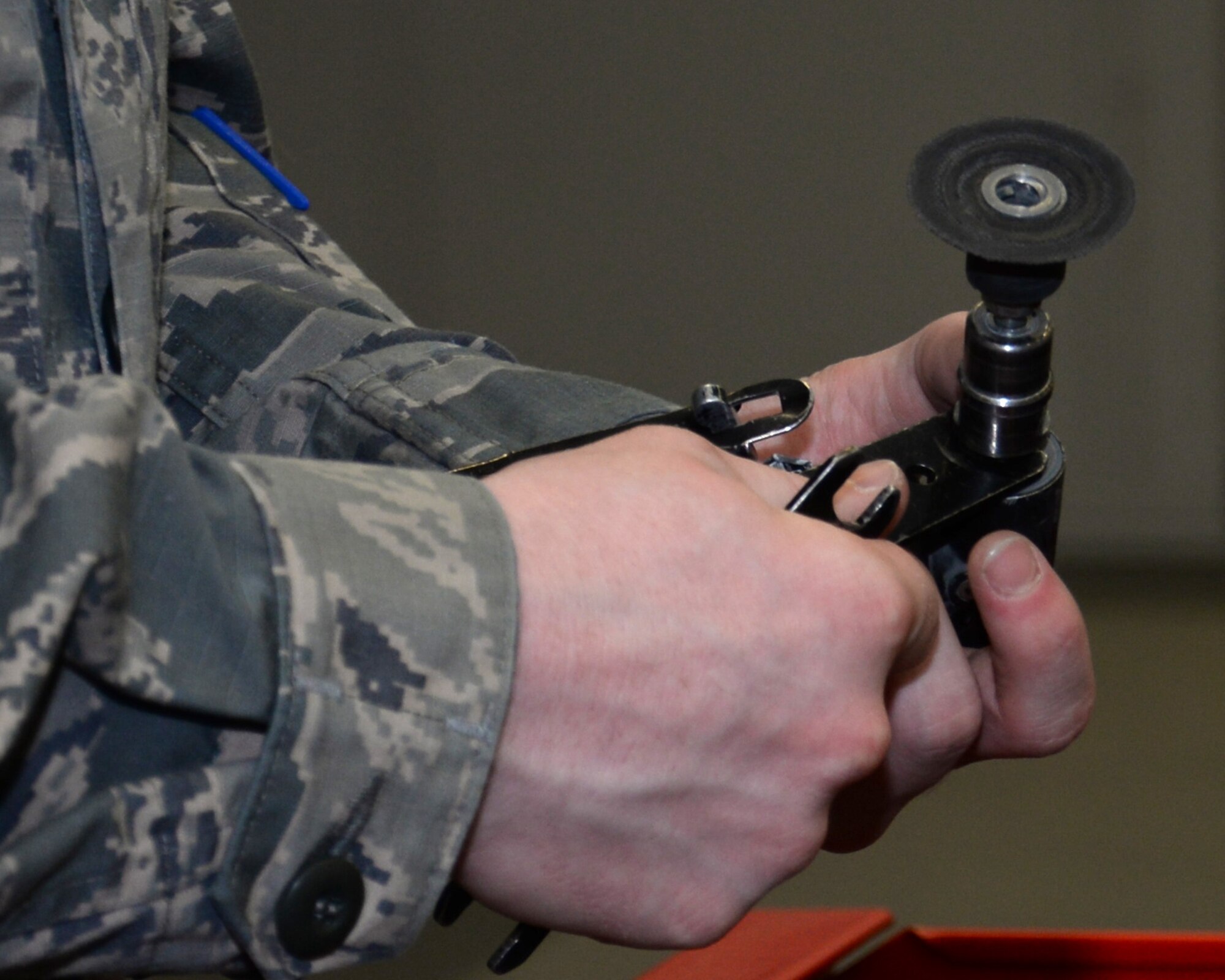 U.S. Air Force Airman 1st Class Donavan Jerles, 100th Maintenance Squadron Aircraft Structural apprentice from Gulf Shores, Ala., uses an angle grinder to work on a honeycomb core while preparing the material for fiberglass repair June 3, 2015, on RAF Mildenhall, England. The 90 degree angle grinder spins a sanding disk at a rapid rate to sand the excess core. The core is a similar structure to a bee’s honeycomb made from phenolic. (U.S. Air Force photo by Gina Randall/Released)