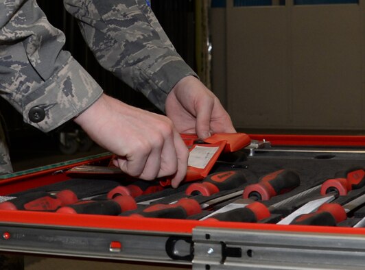 U.S. Air Force Airman 1st Class Donavan Jerles, 100th Maintenance Squadron Aircraft Structural apprentice from Gulf Shores, Ala., selects tools to work on a honeycomb core while preparing the material for fiberglass repair June 3, 2015, on RAF Mildenhall, England. The honeycomb core is used to distribute the load stress across of the entirety of the panel. When an aircraft receives damage to skins (outside metal) the section personnel remove damage and repair it by adding more material. (U.S. Air Force photo by Gina Randall/Released)
