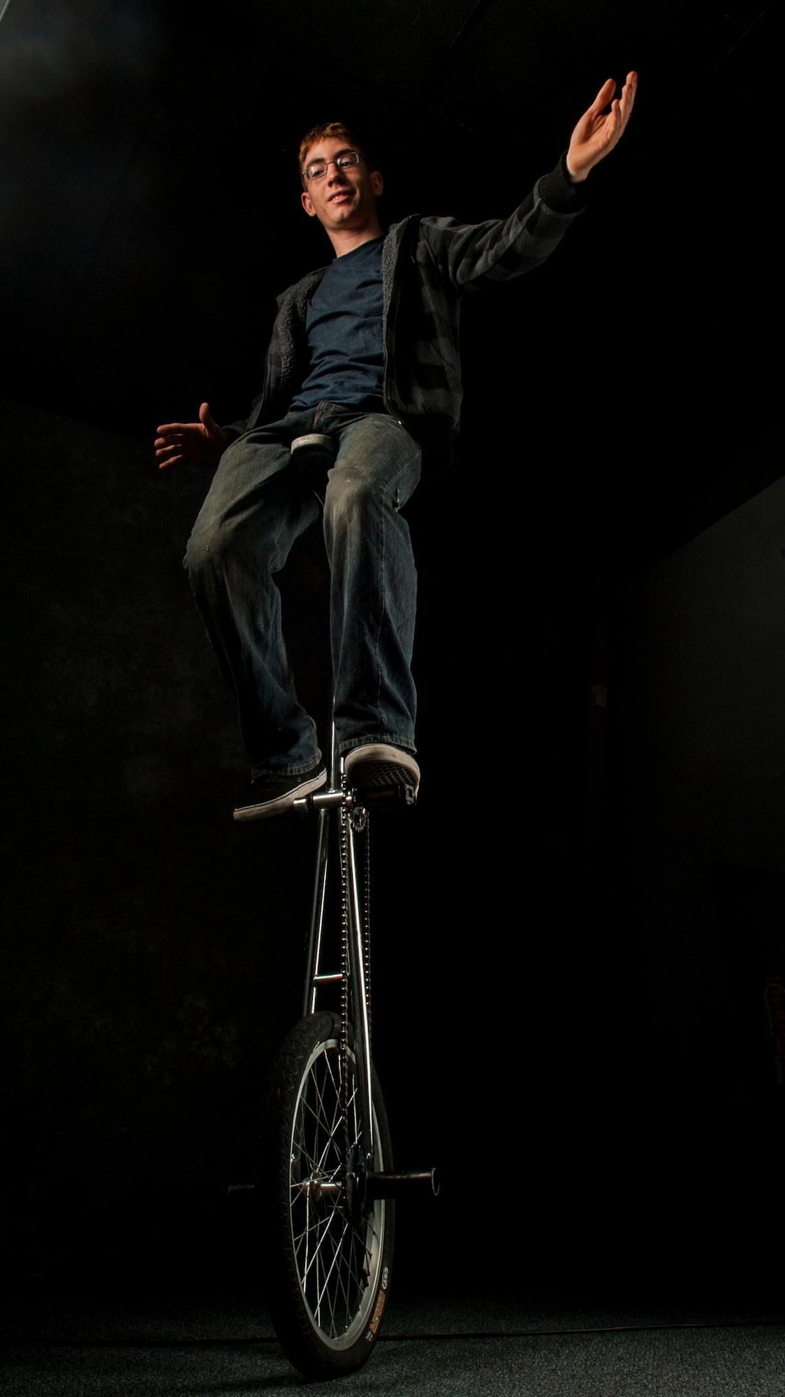 Airman 1st Class Robert Taylor, 5th Security Forces Squadron alpha flight team member, balances on his giraffe unicycle on Minot Air Force Base, N.D., Oct. 3, 2014. Taylor, who once worked for Cirque Du Soleil, is approaching his seventh year as a unicyclist and his second year as an Airman. (U.S. Air Force photo/Senior Airman Stephanie Morris)