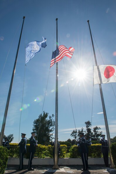 Kadena Honor Guard members lower the flags during the National Flag Day ceremony on Kadena Air Base, Japan, June 15, 2015. The ceremony included a decommissioning of an American flag by honor guard personnel, which was retired along with other flags toward the end of the event. Retired flags are destroyed according to the United States Flag Code which states, "The flag, when it is in such condition that it is no longer a fitting emblem of display, should be destroyed in a dignified way, preferably by burning. (U.S. Air Force photo by Senior Airman Stephen G. Eigel)