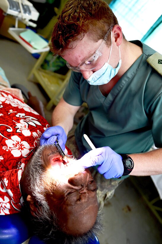 New Zealand Navy Lt. Joseph Foster injects a patient with a local anesthetic before performing a tooth extraction during a Pacific Partnership event at the Betio Hospital in Tarawa, Kiribati, June 5, 2015. 