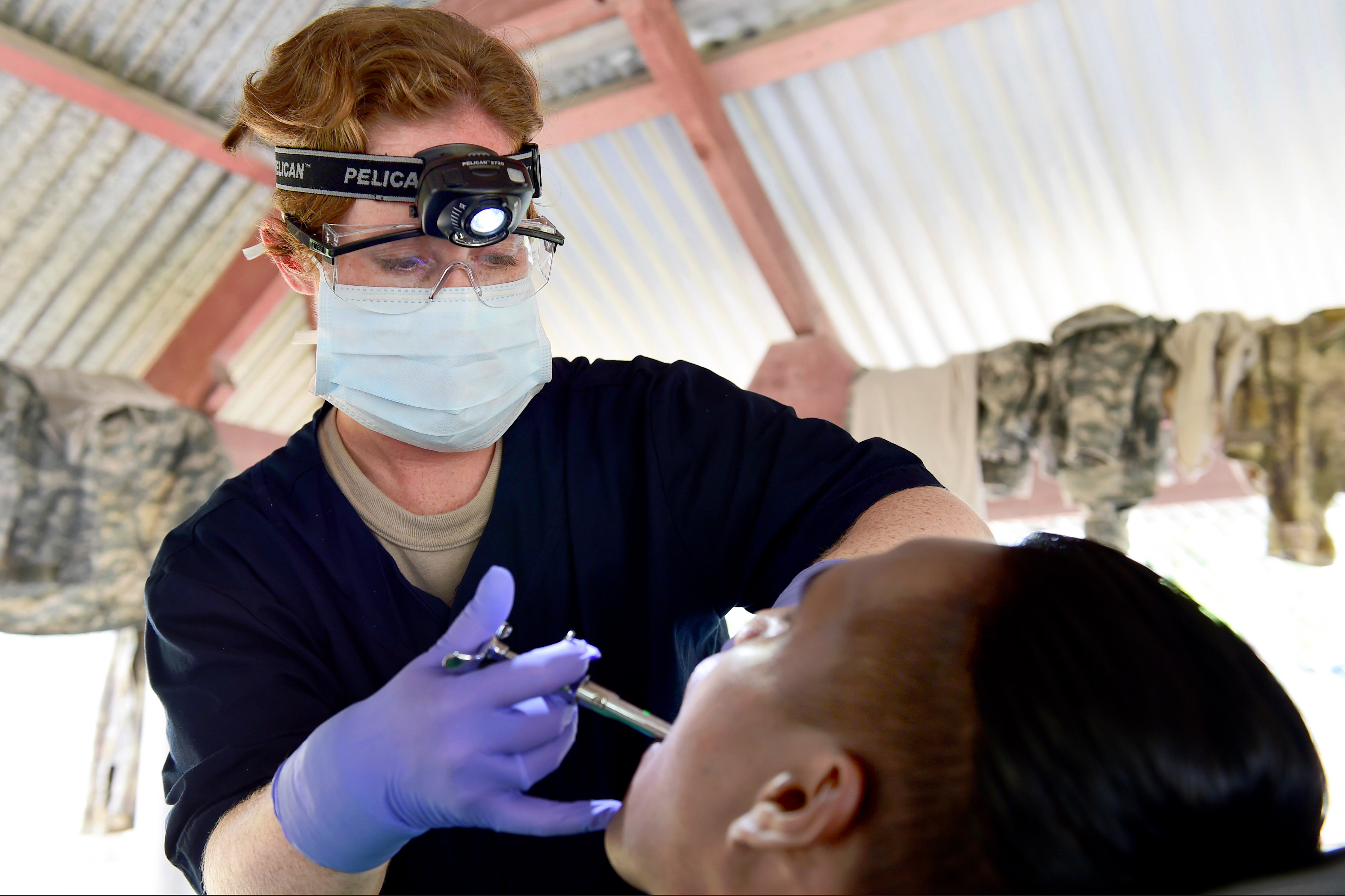 U.S. Army Capt. Jennifer Silvers injects a patient with a local