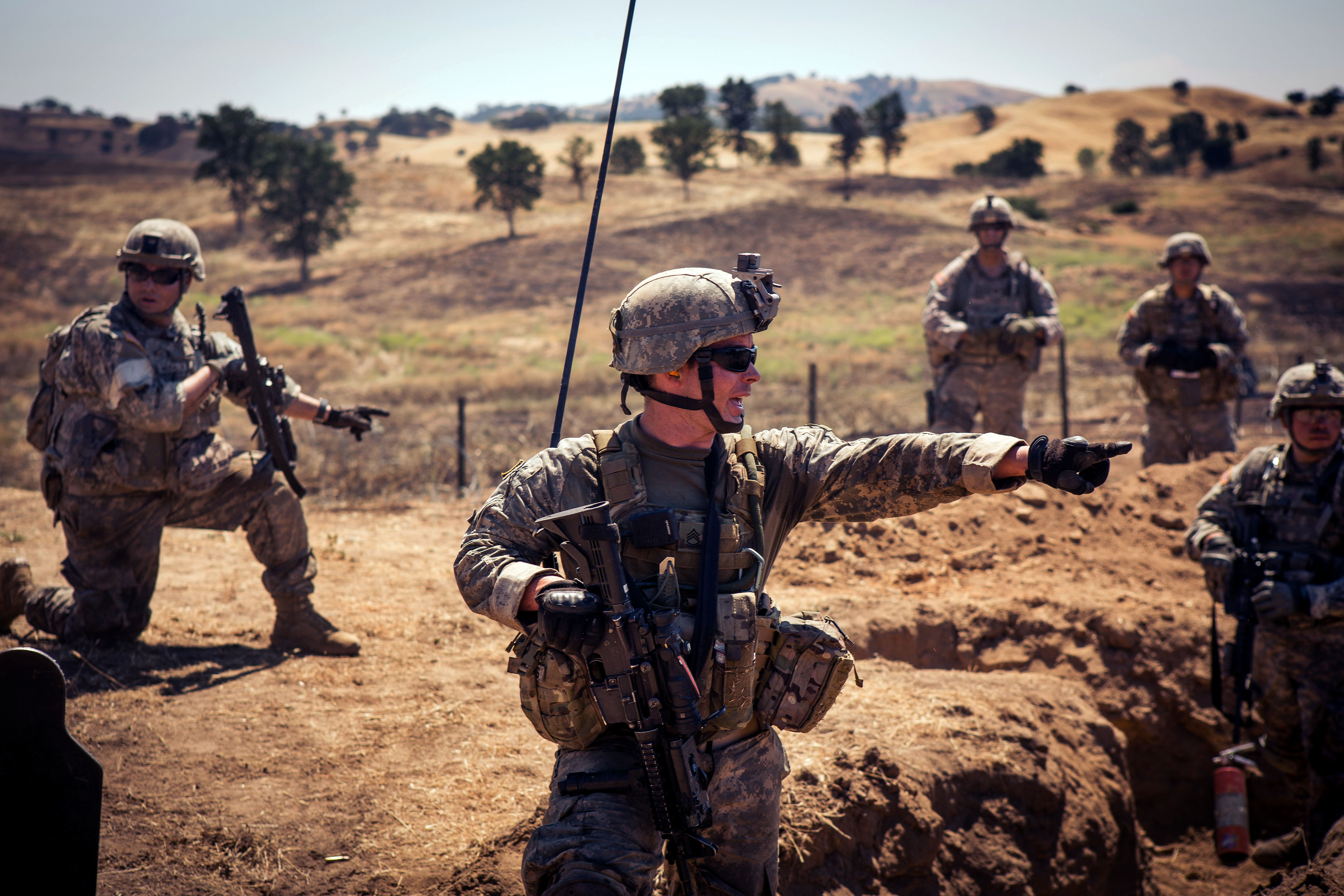 Army Sgt. 1st Class Darren Toedt, center, yells out commands as his ...