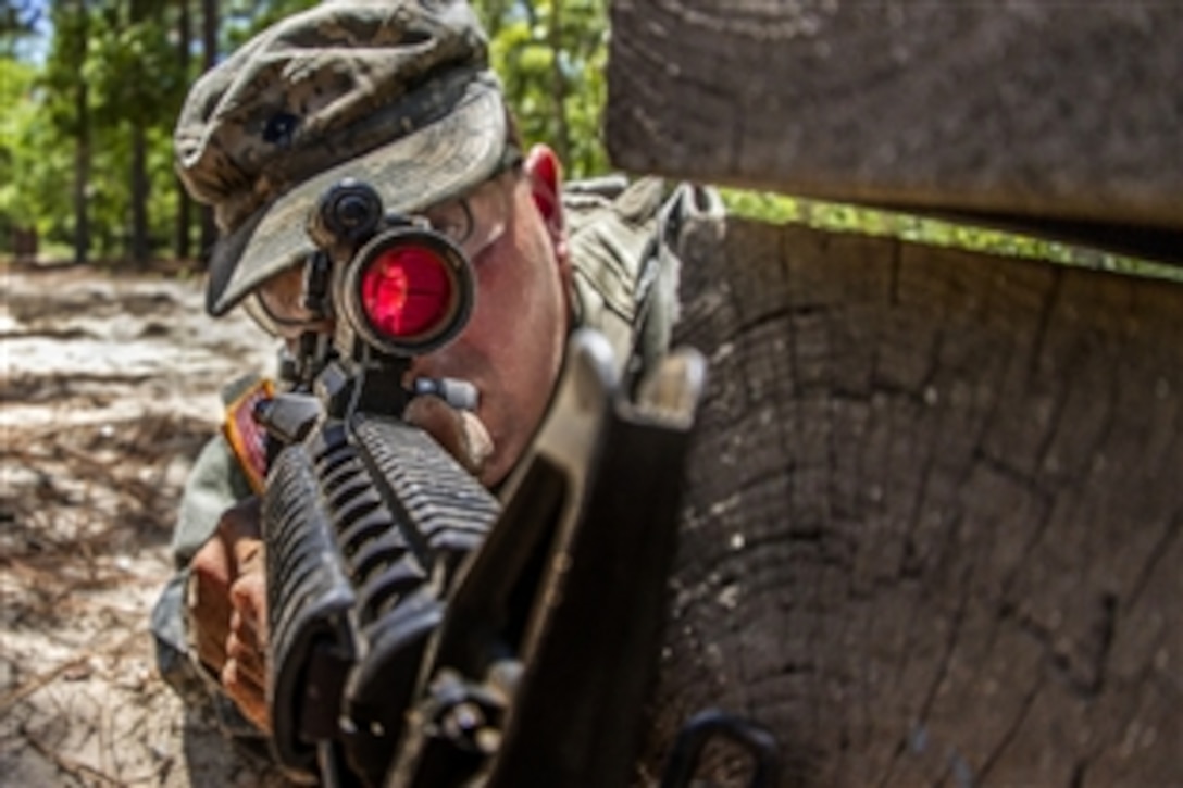 A soldier provides security for his battle buddy at the hand grenade assault course on Fort Jackson, S.C., June 13, 2015. The soldiers are Army active-duty, Army Reserve and National Guard soldiers assigned to Basic Combat Training, Company B, 3rd Battalion, 39th Infantry Regiment. 