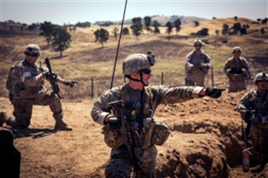 Army Sgt. 1st Class Darren Toedt, center, gives commands as his platoon consolidates and reorganizes following an attack live-fire exercise at Fort Hunter Liggett, Calif., June 12, 2015. Toedt is a platoon sergeant assigned to Company C, 1st Battalion, 160th Infantry Regiment.