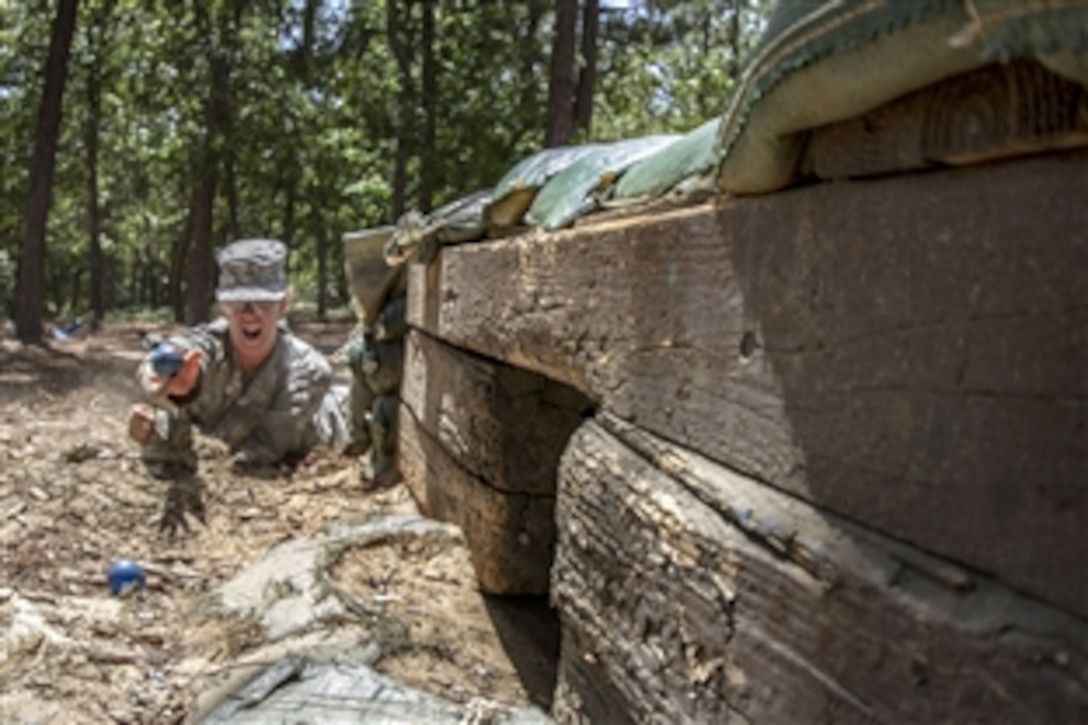 A soldier tosses a practice grenades into a bunker at the hand grenade assault course on Fort Jackson, S.C., June 13, 2015. 