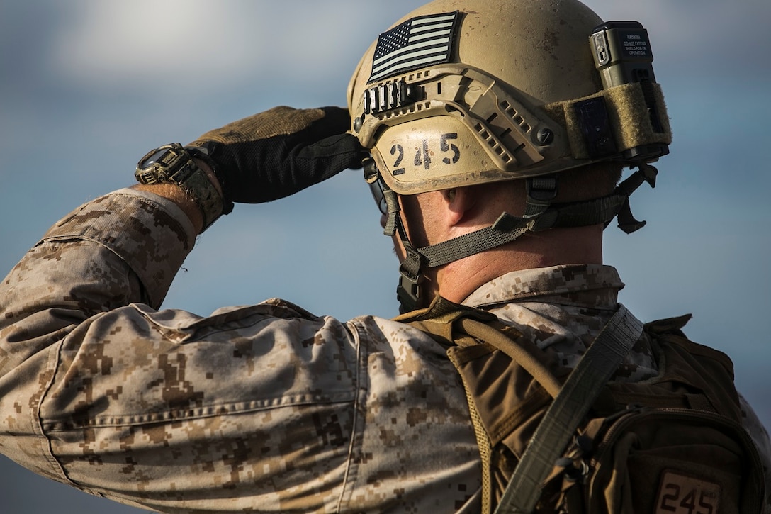 U.S. Marine Sgt. Jesse Kimble observes his target during a deck shoot aboard the USS Essex (LHD 2) in the South China Sea, June 12, 2015. Kimble is a member of the 15th Marine Expeditionary Unit’s Maritime Raid Force. These Marines practice several types of shooting, such as shooting on the move, to imitate the type of engagements they would have to use in a real-life scenario. (U.S. Marine Corps photo by Cpl. Anna Albrecht/Released)