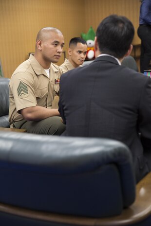 Representatives from Headquarters and Headquarters Squadron and Marine Aerial Transport Refueler Squadron 152 aboard Marine Corps Air Station Iwakuni, Japan, report to the mayor of Iwakuni at city hall June 3, 2015, after receiving awards from the Japan Good Deeds Association during their 65th Spring Commendation Ceremony in May. H&HS and VMGR-152 received the awards for assisting the local community whose homes were affected by a mudslide in August 2014.