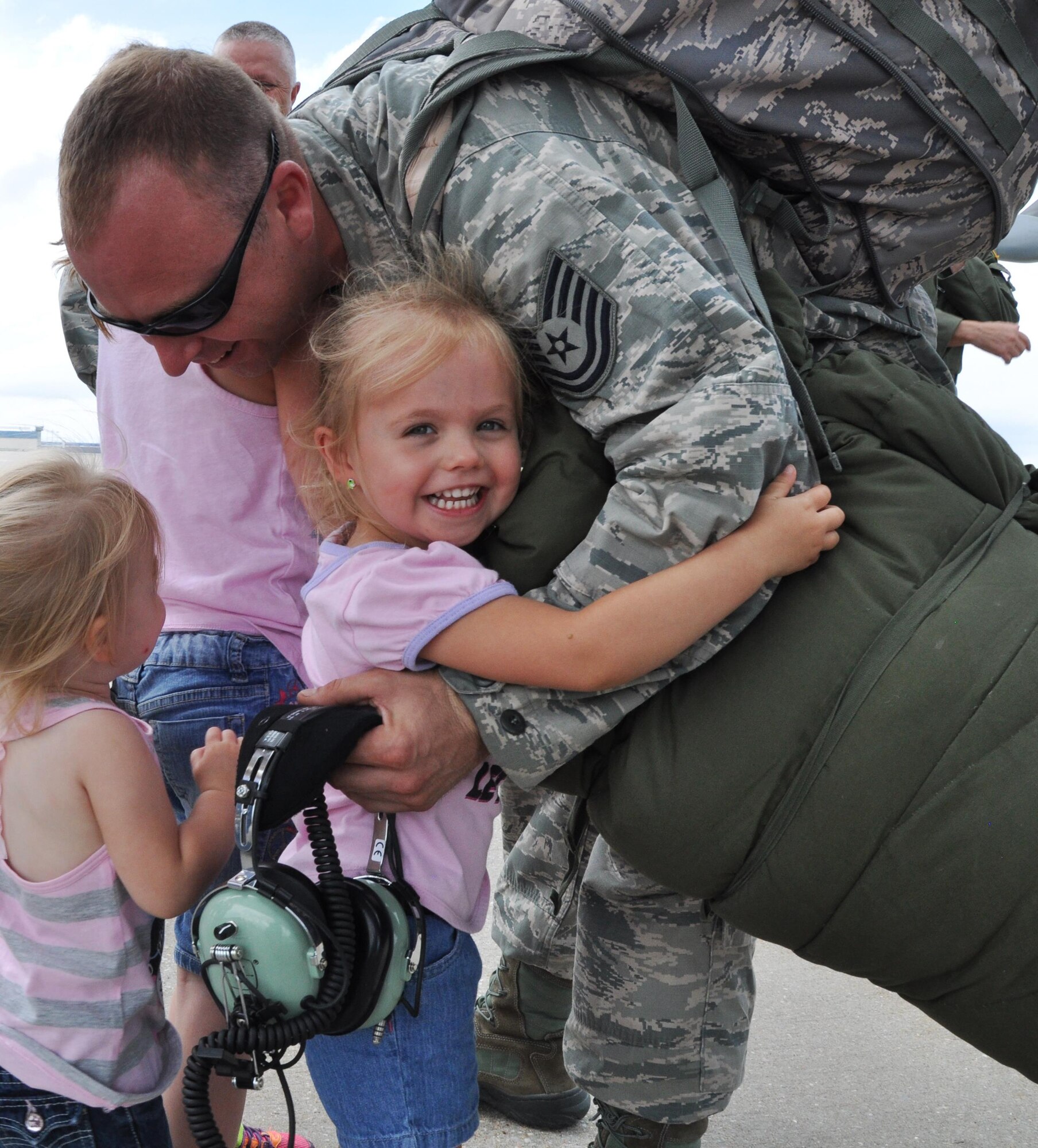 Ainee smiles as she greets her father,Tech. Sgt. Steven Upchurch, 931st Maintenance Squadron crew chief, after returning from a deployment to Southwest Asia, June 12, 2015, at McConnell Air Force Base, Kan. During the deployment, the 931 ARG performed aircraft maintenance and filled other support roles. (U.S. Air Force photo by Tech. Sgt. Abigail Klein)