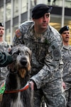 New York Army National Guard Sgt. Adam Drobecker with one of the 69th
Infantry's Wolfhound Mascots.
