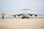 A C-17 Globemaster III from the Mississippi Air National Guard is being directed to park at Orlando Sanford International Airport, Jan. 21, 2010. The C-17 was carrying over 50 evacuees from Haiti.