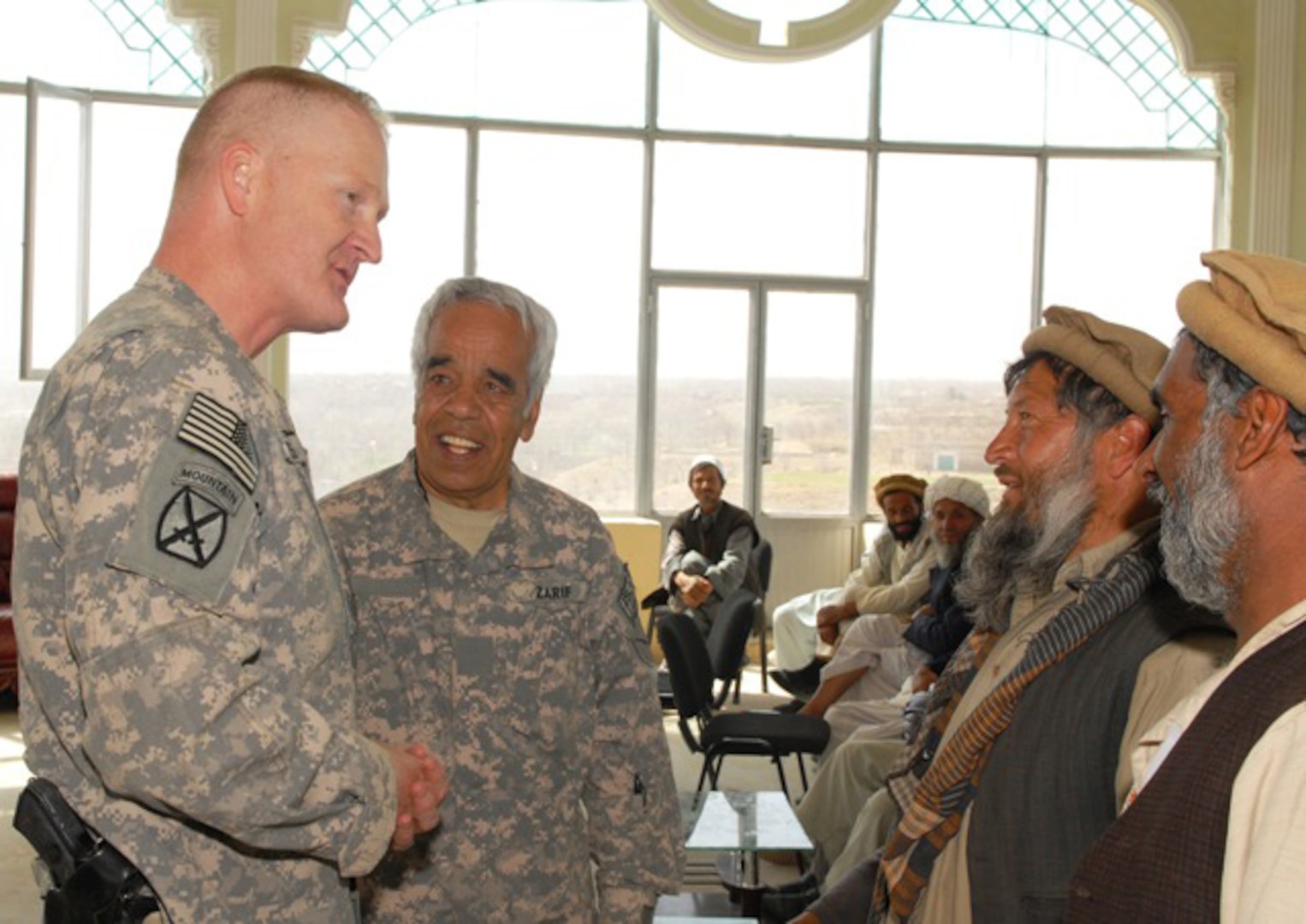Army Col. Hunter Mathews, Kentucky National Guard Agribusiness Development Team commander, speaks to Afghan soybean farmers about their farms during the inauguration ceremony for the Afghan Soybean Farmers Association at the Kapisa Governor’s compound March 17, 2011. The Kentucky ADT purchased seed and fertilizer for the farmers earlier this year. (U.S. Army photo by Spc. James Wilton) (Released)