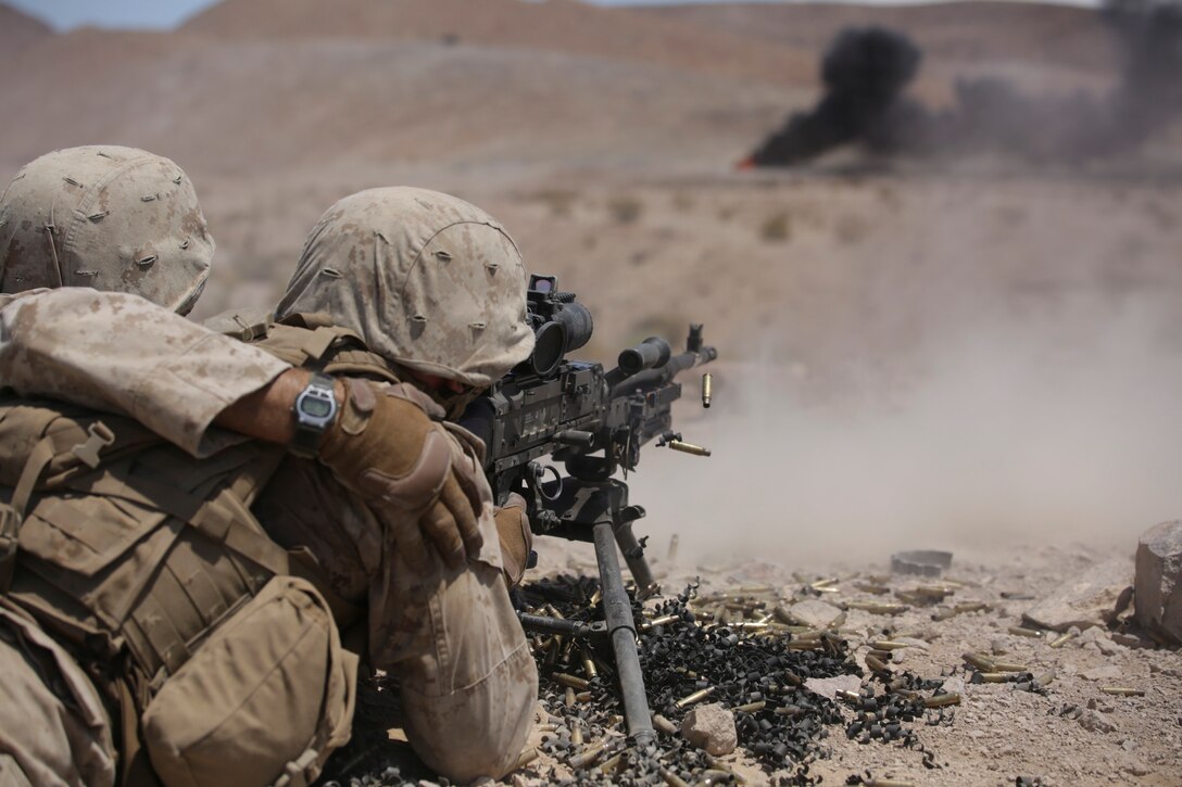 Lance Cpl. Michael Spencer, team leader with Company B, 1st Battalion, 23rd Marine Regiment, 4th Marine Division, Marine Forces Reserve, and Lance Cpl. John Coleman, machine gunner with Bravo Company, shoot down range during the live fire company attacks during the Integrated Training Exercise 4-15 aboard Marine Corps Air Ground Combat Center Twentynine Palms, Calif., June 13, 2015. The exercise consisted of a series of combined shooting, fire maneuver, and movement in which Marines simulated an encounter and fire suppression against hostile enemies. (U.S Marine Corps photo by Cpl. Ian Ferro)