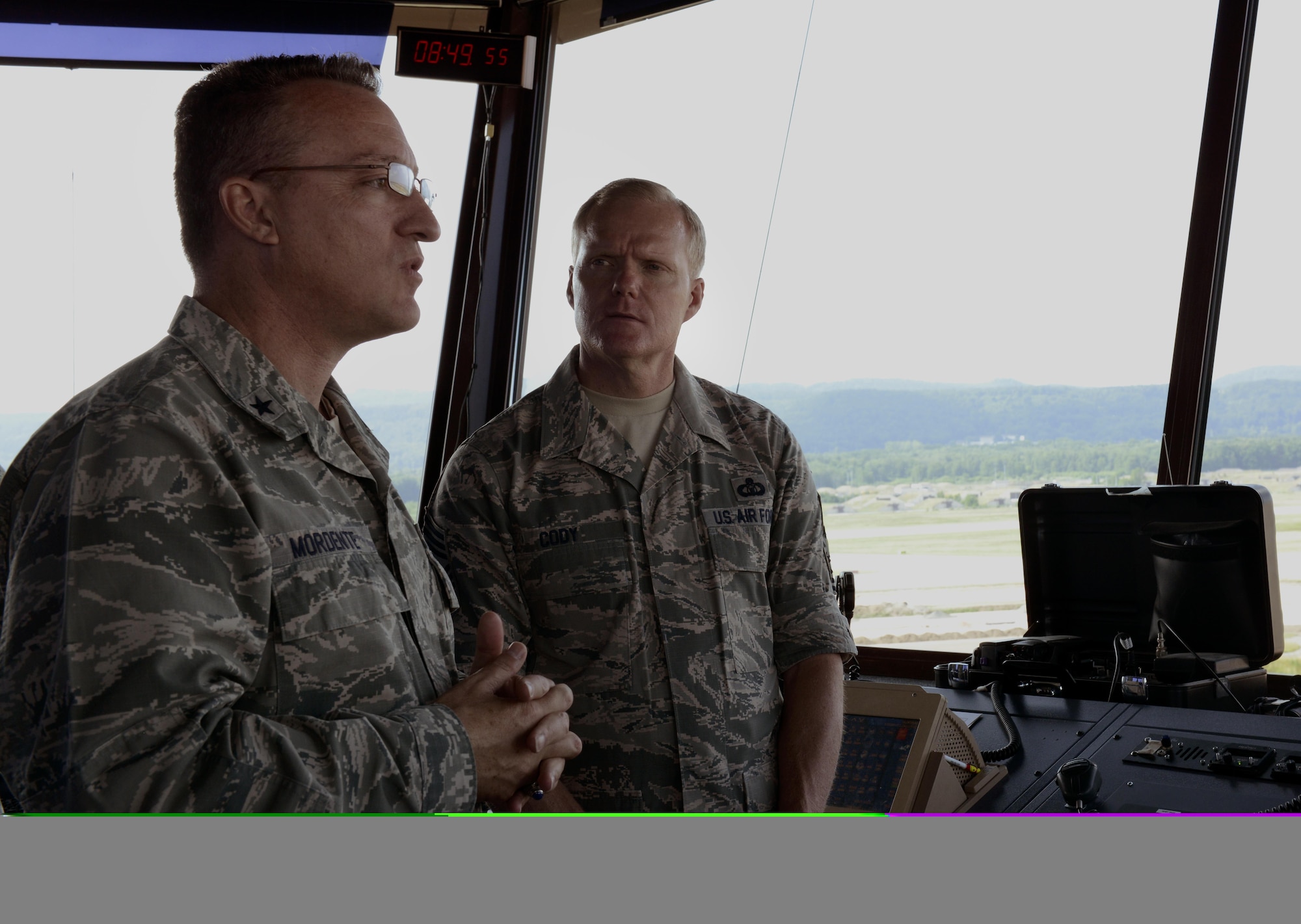 Brig. Gen. Patrick X. Mordente, the 86th Airlift Wing commander, demonstrates to Chief Master Sgt. of the Air Force James A. Cody the different aspects of Ramstein Air Base, Germany, from the control tower June 15, 2015. An all call with Cody was held during his visit to give Airmen an opportunity to ask him questions they had about Air Force policies directly. (U.S. Air Force photo/Airman 1st Class Tryphena Mayhugh)