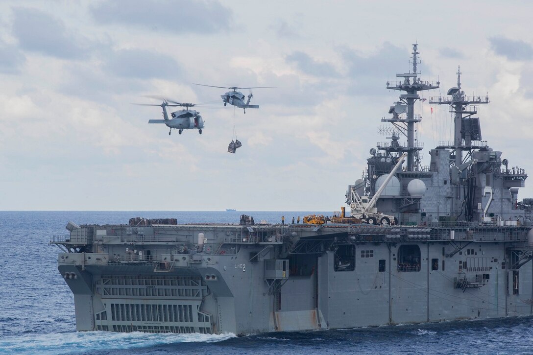 MH-60S Sea Hawks with Essex Amphibious Ready Group deliver supplies to the USS Essex (LHD 2) during a replenishment at sea in the South China Sea, June 14, 2015. Marines and sailors with the 15th Marine Expeditionary Unit, and Essex ARG worked together to offload food, maintenance parts, and letters from home. (U.S. Marine Corps photo by Sgt. Emmanuel Ramos/Released)