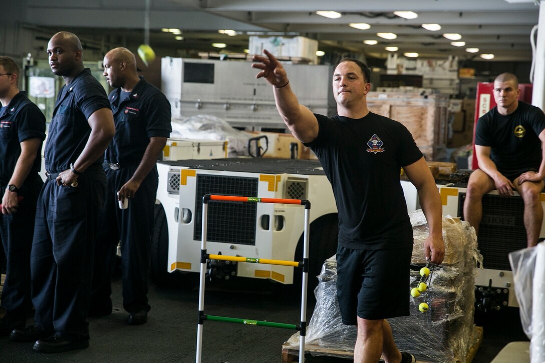U.S. Marine Sgt. Daniel Mullis plays a game in the hangar bay of the USS Essex (LHD 2) at sea in the Strait of Malacca, June 15, 2015. Mullis is a member of the 15th Marine Expeditionary Unit’s Maritime Raid Force. The Marines with the 15th MEU and Sailors with the Essex Amphibious Ready Group enjoyed a “Steel Beach,” which consisted of grilling, music, and games. (U.S. Marine Corps photo by Cpl. Anna Albrecht/Released)