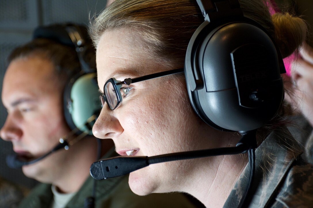 Master Sgt. Leanna Jack looks on as a C-5M Super Galaxy connects with a KC-10 Extender June 6, 2015 over San Francisco. Jack was one of more than 15 Air Force Reservists, assigned to the 349th Air Mobility Wing at Travis Air Force Base, California, who took part in an orientation flight. The flight allowed wing top performers to experience the wing's aerial refueling mission. During the weekend, the 349th AMW hosted an Air Force Speciality Code Training Weekend, providing reservists with hands-on, realistic training that helps members hone their skills. The AFSC Training Weekend centered around the wing's ability to respond to a major earthquake in northern California, while working in concert with other military, federal and state agencies to provide relief and support where needed. (U.S. Air Force photo by 2nd Lt. Stephen J. Collier/Released)