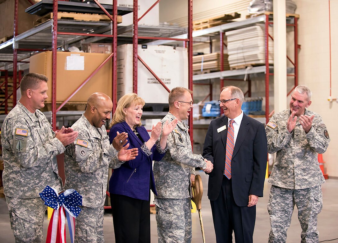 U.S. Army Medical Research and Materiel Command and Fort Detrick Commander Maj. Gen. Brian C. Lein shakes hands with Frederick City Mayor Randy McClement following the ribbon cutting for the Nallin Farm Gate and Consolidated Logistics Facility. 