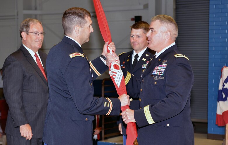 (second from left) Lt. Col. Stephen F. Murphy, incoming commander, receives the unit colors from Brig. Gen. Richard G. Kaiser, U.S. Army Corps of Engineers Great Lakes and Ohio River Division commander, during the change of command ceremony at the Tennessee National Guard Armory in Nashville, Tenn. June 16, 2015.  Looking on is Nashville District Deputy District Engineer for Program Management Mike Wilson, (far left) and outgoing commander, Lt. Col. John L. Hudson. (center)  