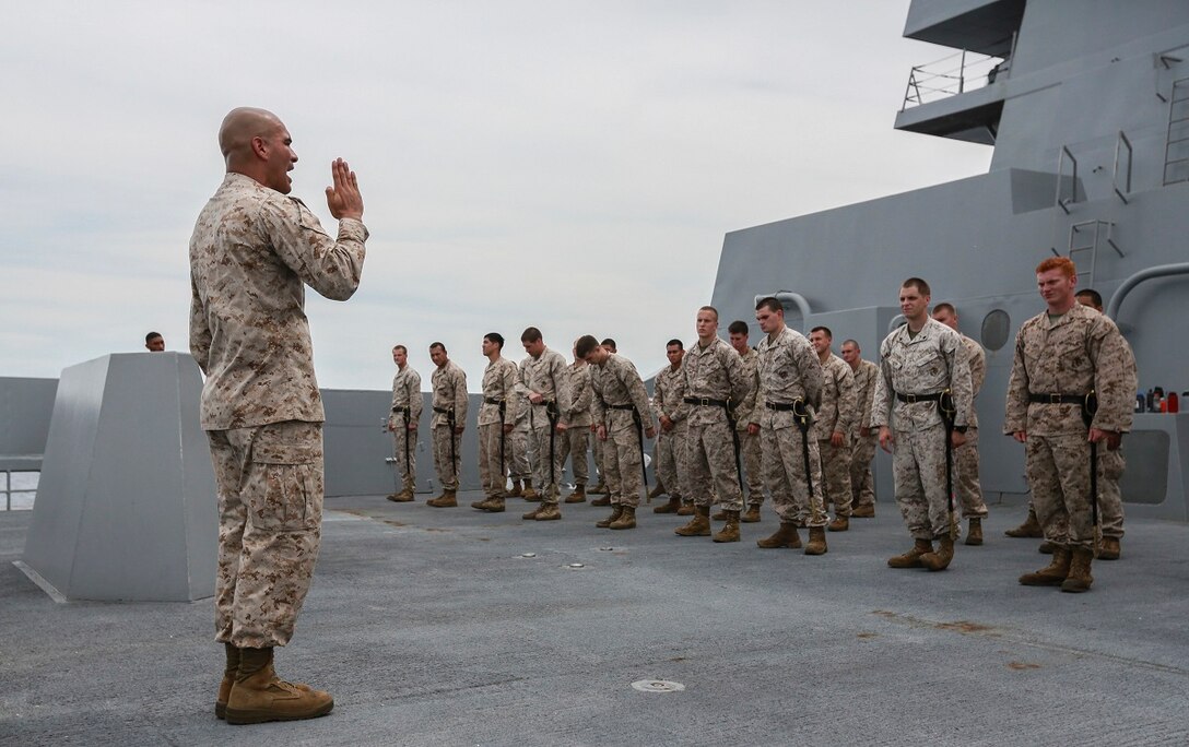 U.S. Marine Staff Sgt. Jose Mireles instructs his students during sword manual for the Corporals Course aboard the USS Anchorage (LPD 23) in the South China Sea, June 13, 2015. Mireles is a supply chief with Battalion Landing Team 3rd Battalion, 1st Marine Regiment, 15th Marine Expeditionary Unit, and a faculty advisor for the Corporals Course aboard the USS Anchorage. Marines participate in corporals courses, even while deployed, to ensure they have the tools to be better leaders. (U.S. Marine Corps photo by Sgt. Steve H. Lopez/Released)