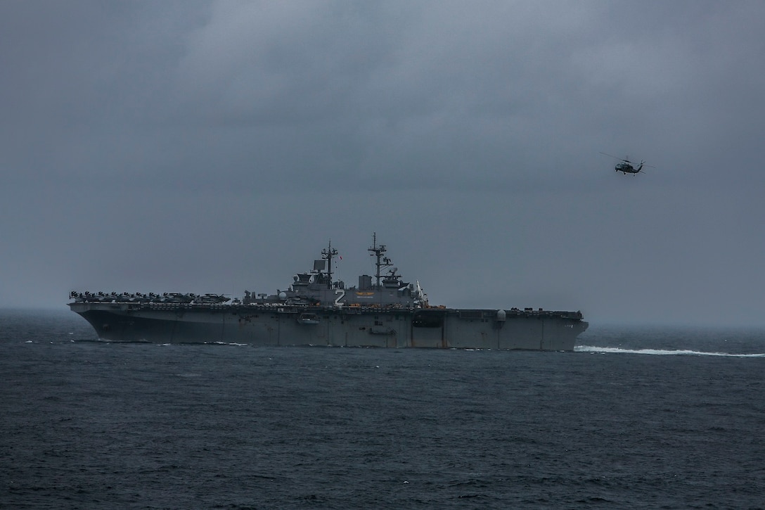 An MH-60S Seahawk conducts a vertical replenishment at sea with the USS Essex (LHD 2), June 14, 2015. The USS Essex receives fuel and stores at sea in order to continue its mission without stopping forward progress as they transition to their 5th Fleet area of responsibility. (U.S. Marine Corps photo by Sgt. Steve H. Lopez/Released)