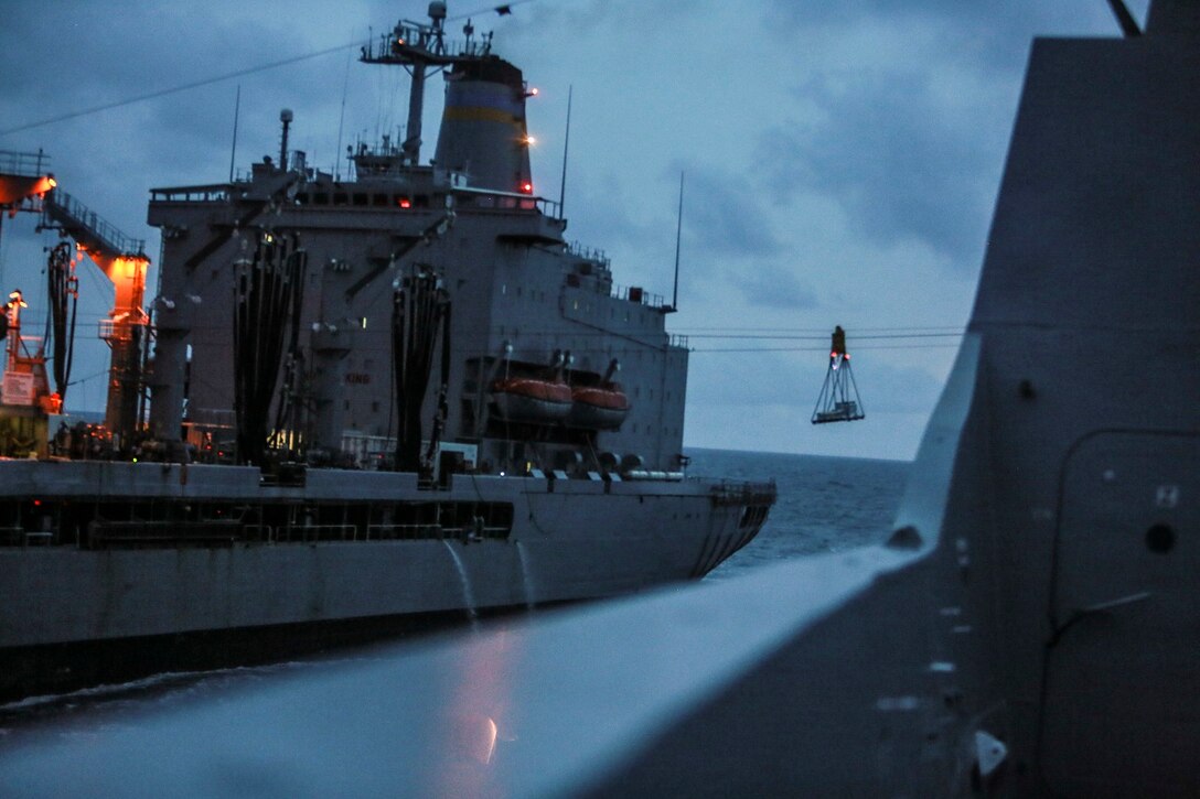 The USS Anchorage (LPD 23) receives supplies and goods from the USNS Walter S. Diehl (T-AO 193) during a replenishment at sea in the South China Sea June 14, 2015. The USS Anchorage receives supplies and stores at sea in order to continue its mission without stopping forward progress as they transition to their 5th Fleet area of responsibility. (U.S. Marine Corps photo by Sgt. Steve H. Lopez/Released)