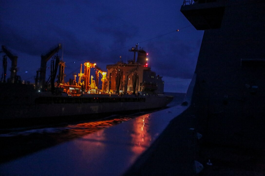 The USS Anchorage (LPD 23) receives supplies and goods from the USNS Walter S. Diehl (T-AO 193) during replenishment at sea in the South China Sea June 14, 2015. The USS Anchorage receives supplies and stores at sea in order to continue its mission without stopping forward progress as they transition to their 5th Fleet area of responsibility. (U.S. Marine Corps photo by Sgt. Steve H. Lopez/Released)