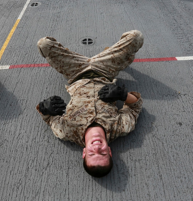 U.S. Marine Cpl. Ayrton Borges rests between exercises during the Marine Corps Martial Arts Program, green belt course, aboard the USS Anchorage (LPD 23) in South China Sea, June 15, 2015. Borges is a welder with Combat Logistics Battalion 15, 15th Marine Expeditionary Unit. These classes help Marines to maintain physical and mental combat readiness throughout their deployment. (U.S. Marine Corps photo by Sgt. Steve H. Lopez/Released)