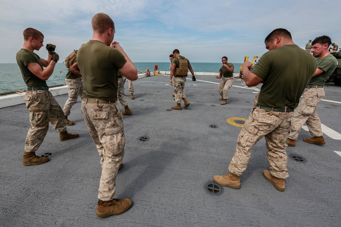 U.S. Marines with Combat Logistics Battalion 15, 15th Marine Expeditionary Unit, shadow-box during a Marine Corps Martial Arts Program, green belt course, aboard the USS Anchorage (LPD 23) in the South China Sea, June 15, 2015. These classes help Marines maintain physical and mental combat readiness throughout their deployment. (U.S. Marine Corps photo by Sgt. Steve H. Lopez/Released)