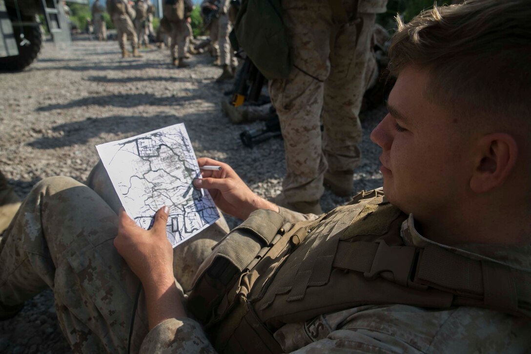 Lance Cpl. Mckinley Cook, from Duvall, Washington, plots points for the final land navigation mission of exercise Fuji Warrior June 2 at the Combined Arms Training Center, Camp Fuji, Japan. Marines spent two days studying land navigation techniques before tackling the dense vegetation of the training area. Fuji Warrior is conducted to instill the Marine Corps ethos of “Every Marine is a rifleman.” This training provided Marines with Headquarters Regiment, 3rd Marine Logistics Group, III Marine Expeditionary Force the opportunity to conduct combat training relevant to current operating environments. Cook is a data network specialist with Headquarters Regiment, 3rd MLG. (U.S. Marine Corps photo by Cpl. Devon Tindle/Released)