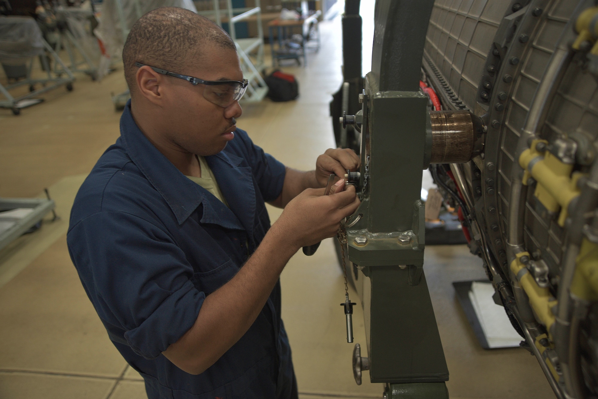 U.S. Air Force Airman 1st Class Adelbert Molyneaux, 35th Maintenance Squadron aerospace propulsion apprentice, tightens a lock on equipment used to stabalize an an F-16 Fighting Falcon engine prior to maintenance on it at Misawa Air Base, Japan, June 9, 2015. Molyneaux is part of a team of “props” responsible for all engine maintenance for not only Misawa AB, but Osan and Kunsan Air Bases in the Republic of Korea. (U.S. Air Force photo by Senior Airman Jose L. Hernandez-Domitilo)