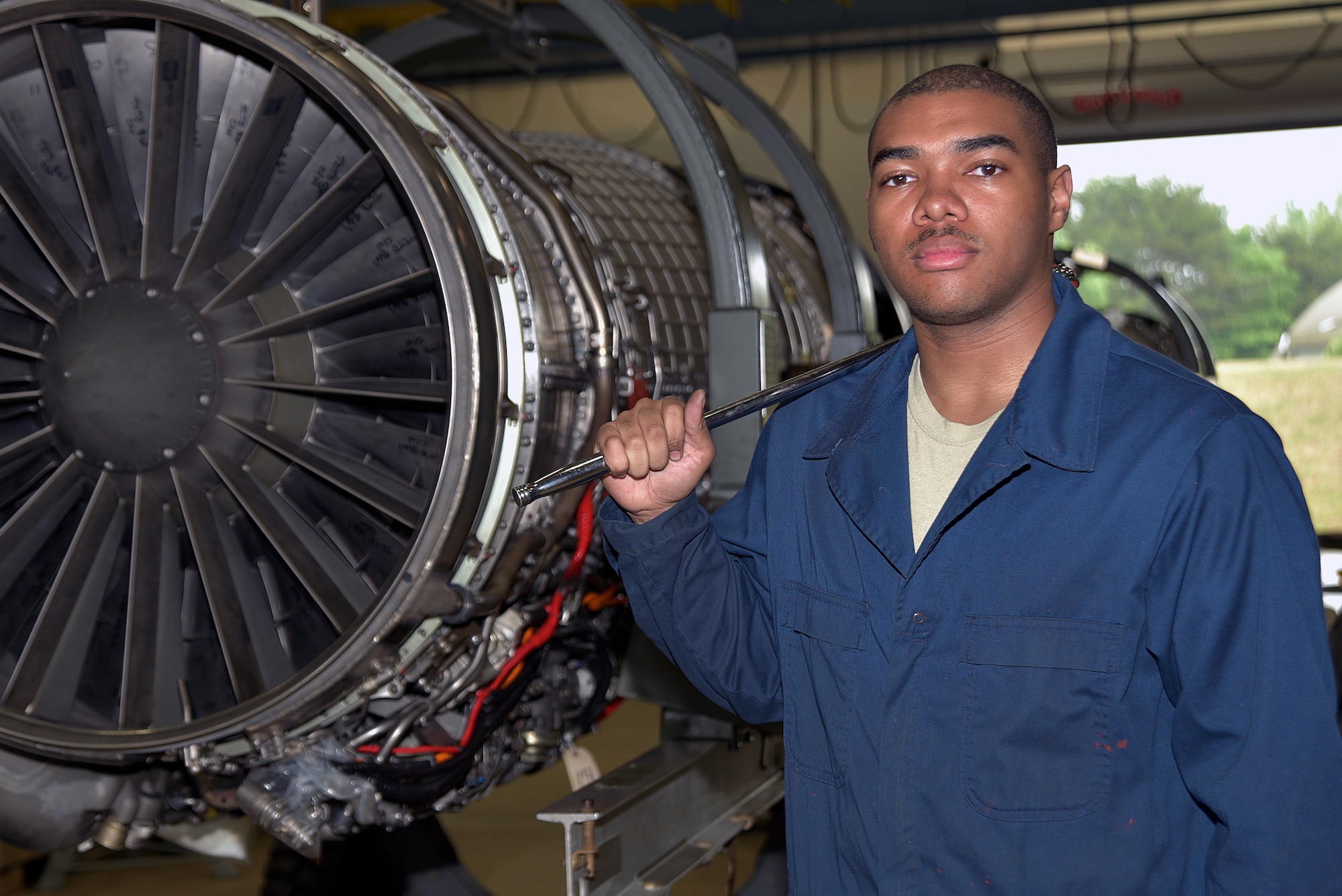 U.S. Air Force Airman 1st Class Adelbert Molyneaux, 35th Maintenance Squadron aerospace propulsion apprentice, stands next to an F-16 Fighting Falcon engine at Misawa Air Base, Japan, June 9, 2015. Fix and maintain F110-GE-100/-129 engines in the Pacific Air Force’s only centralized repair facility that directly supports 3 combat fighter wings. (U.S. Air Force photo by Senior Airman Jose L. Hernandez-Domitilo)