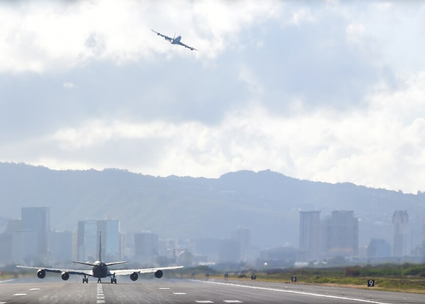 Two KC-135 Stratotankers, from the 96th Air Refueling Squadron, take off during the squadron’s final operational mission on Joint Base Pearl Harbor-Hickam, Hawaii, June 11, 2015. Four KC-135 operated together to executed refueling operations on six F-22 Raptors, from the 199th Fighter Squadron, and accomplished defensive maneuvering as a four ship during the historical flight. (U.S. Air Force Photo by Tech Sgt. Aaron Oelrich/Released)