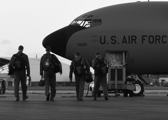 Aircrew from the 96th Air Refeuling Squadron step to their KC-135 Stratotankers for the final operational mission of the 96th ARS on Joint Base Pearl Harbor-Hickam, Hawaii, June 11, 2015. The crew will execute aerial refueling and defensive maneuvering with three other KC-135 aircraft to mark the historic final mission. (U.S. Air Force Photo by Tech Sgt. Aaron Oelrich/Released)