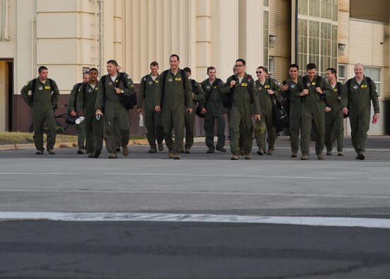 Aircrew from the 96th Air Refeuling Squadron step to their KC-135 Stratotankers for the final operational mission of the 96th ARS on Joint Base Pearl Harbor-Hickam, Hawaii, June 11, 2015. The aircrews will execute aerial refueling and defensive maneuvering in four KC-135s to mark the historic final mission. (U.S. Air Force Photo by Tech Sgt. Aaron Oelrich/Released)
