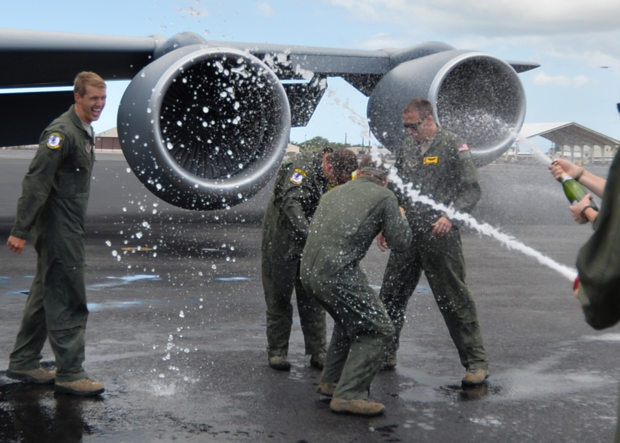 Aircrew from the 96th Air Refueling Squadron, get a wet welcome back to celebrate the squadron’s last operational flight on Joint Base Pearl Harbor-Hickam, Hawaii, June 11, 2015. To mark the historic final mission four KC-135 Stratotankers showed the range of KC-135 capabilities by conducting aerial refueling and defensive maneuvering as a four ship. (U.S. Air Force Photo by Capt. Nicole White/Released)