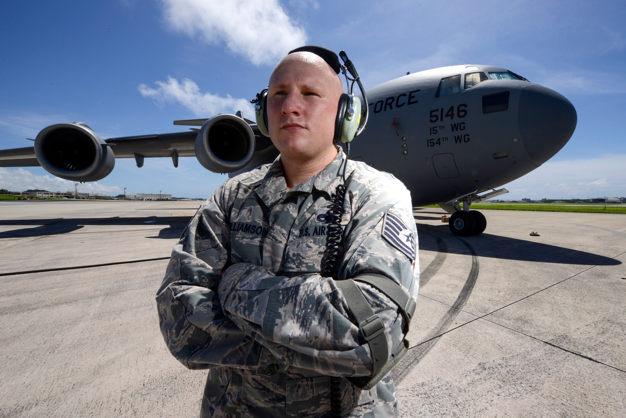 U.S. Air Force Tech. Sgt. David Williamson, 733rd Air Mobility Squadon, stands next to a 36th Airlift Squadron C-17 Globemaster III cargo aircraft on the Kadena Air Base, Japan, flightline June 9, 2015. In addition to the hard work he puts into his Air Force career, Williamson also strives to improve his rap career outside the uniform. (U.S. Air Force photo by Staff Sgt. Maeson L. Elleman)