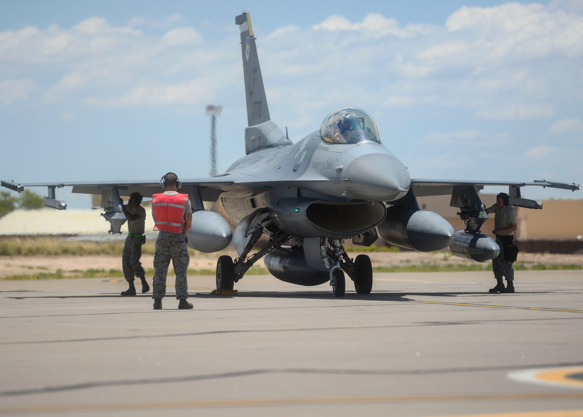 An F-16 Fighting Falcon undergoes a post flight inspection before taxing into its new home at Holloman Air Force Base, N.M., June 16, 2015. Luke Air Force Base, Ariz. has transferred the 54th Fighter Group, which consists of two squadrons, in order to conduct their F-16 training in Holloman’s airspace. (U.S. Air Force photo by Senior Airman Chase Cannon / Released)
