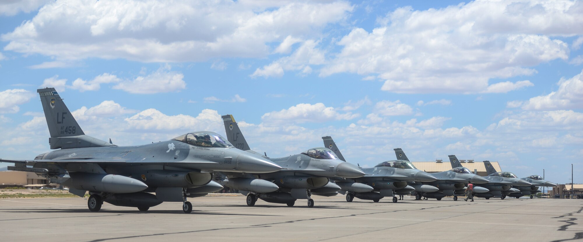 Six F-16 Fighting Falcons sit on the flight line at Holloman Air Force Base, N.M., June 16, 2015. The 308th Fighter Squadron and their F-16s have moved their base of operations to Holloman as a tenant unit, along with other squadrons from the 54th Fighter Group. The 54th Fighter Group will be activating the 314th Fighter Squadron with the 12 F-16s that has been transferred to Holloman. In March of 2014, the 54th Fighter Group was activated at Holloman. The 314th FS is the fourth squadron to transfer from Luke.  (U.S. Air Force photo by Senior Airman Chase Cannon / Released)