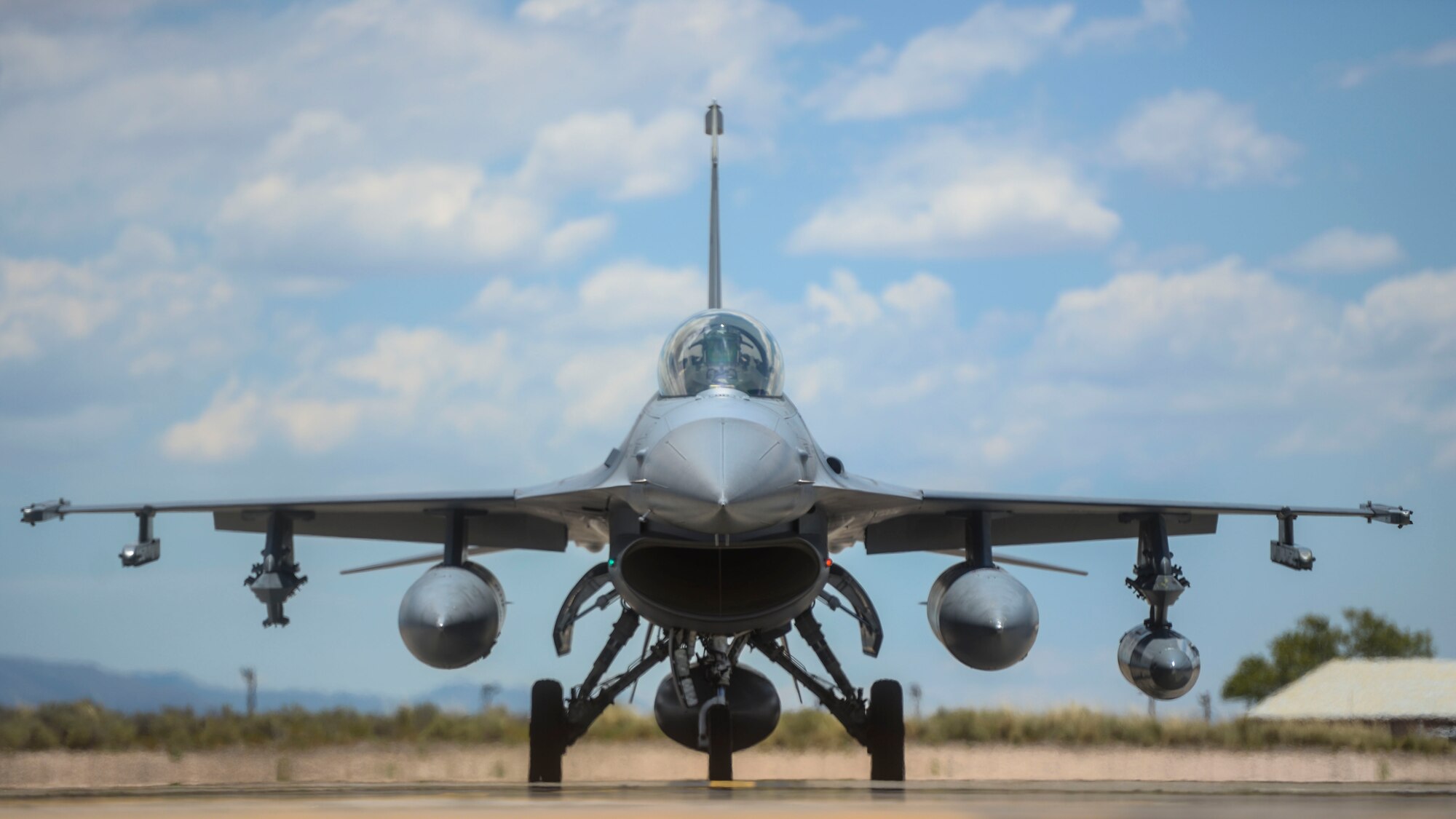 An F-16 Fighting Falcon from the 314th Fighter Squadron taxis toward its new home in the hangars at Holloman Air Force base, N.M., June 16, 2015. The 308th Fighter Squadron and their F-16s have moved their base of operations to Holloman as a tenant unit, along with other squadrons from the 54th Fighter Group. The 54th Fighter Group will be activating the 314th Fighter Squadron with the 12 F-16s that has been transferred to Holloman. In March of 2014, the 54th Fighter Group was activated at Holloman, The 314th FS is the second squadron to transfer from Luke.  (U.S. Air Force photo by Senior Airman Chase Cannon / Released)