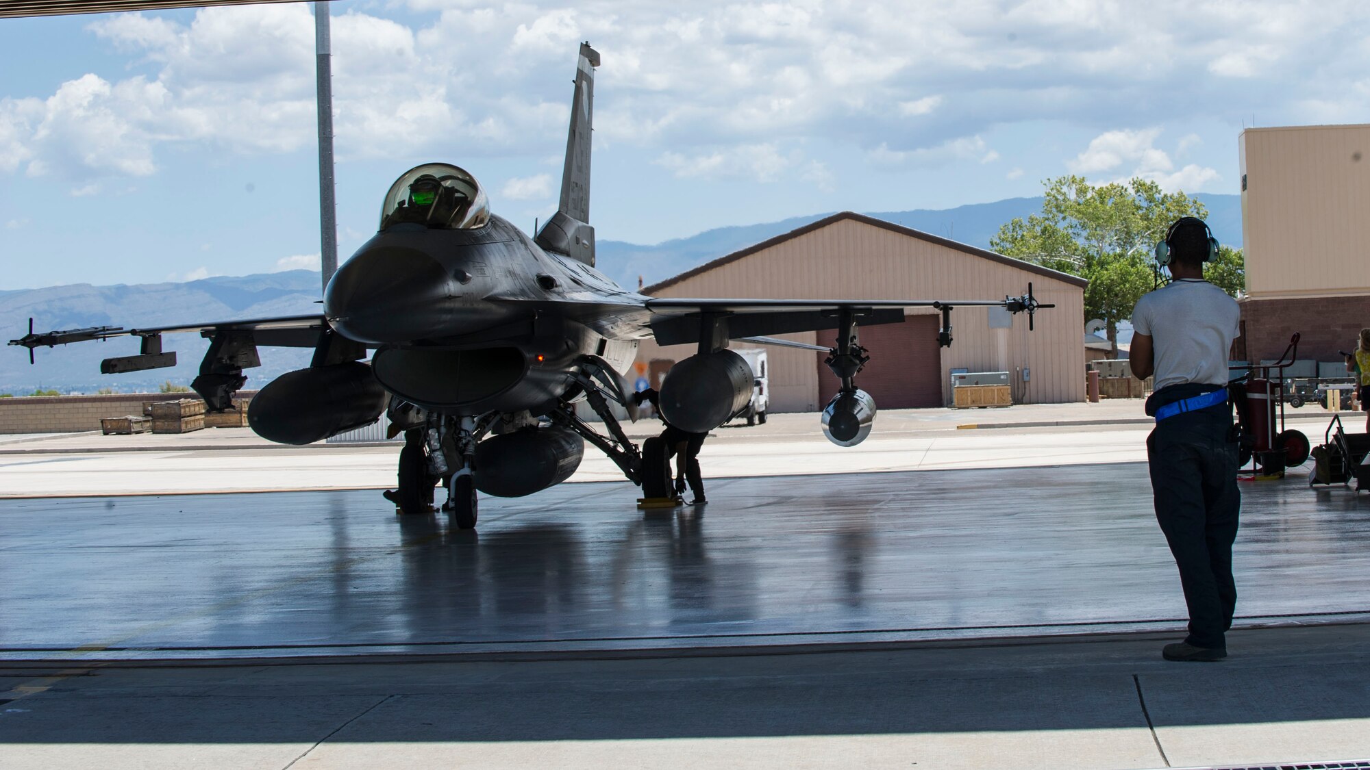 An F-16 Fighting Falcon from Luke Air Force Base, Ariz., parks in a hangar after arriving at Holloman Air Force Base, N.M., June 16, 2015. The 54th Fighter Group will be activating the 314th Fighter Squadron with the 12 F-16s that have been transferred to Holloman. In March of 2014, the 54th Fighter Group was activated at Holloman. The 314th FS is the second squadron to transfer from Luke. (U.S. Air Force photo by Airman 1st Class Emily Kenney / Released)


