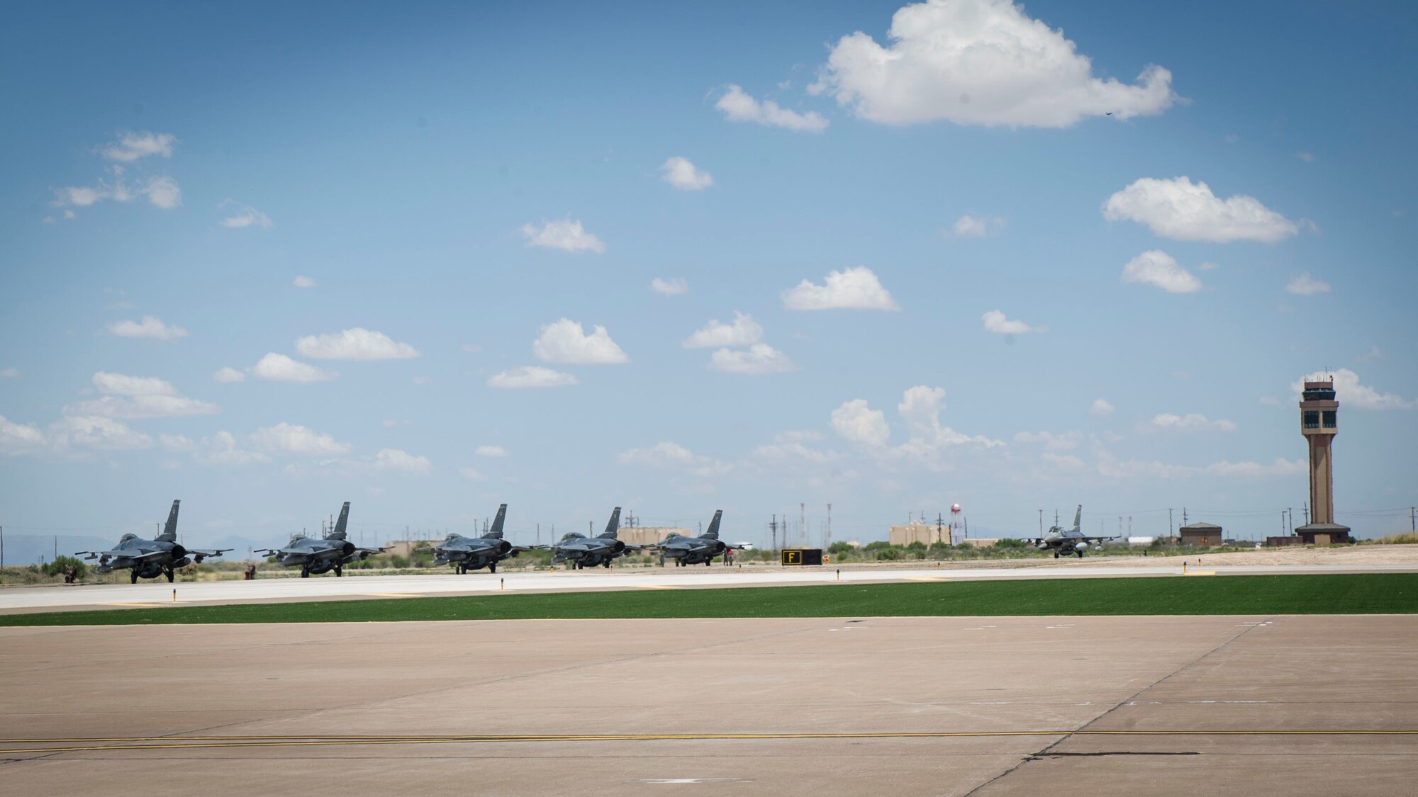 F-16 Fighting Falcons from Luke Air Force Base, Ariz., line up for a post-flight inspection after being transferred to Holloman Air Force Base, N.M., June 16, 2015. Luke has transferred the 54th Fighter Group, which consists of four squadrons in order to conduct their F-16 training in Holloman’s airspace. (U.S. Air Force photo by Airman 1st Class Emily Kenney / Released)
