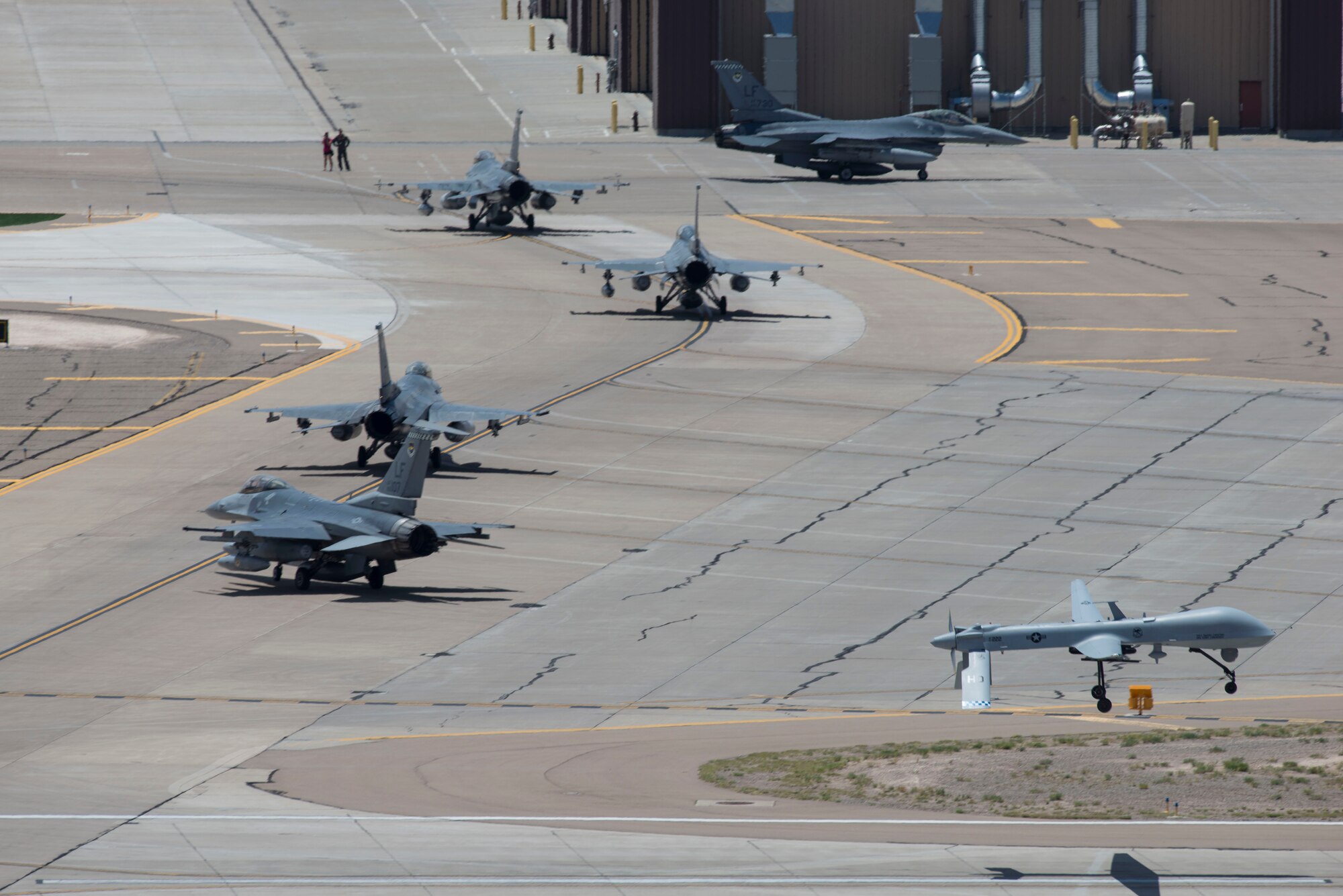 F-16 Fighting Falcons from the 308th Fighter Squadron taxi toward their hangars as a new tenant unit at Holloman Air Force Base, N.M, June 16, 2015. Luke Air Force Base, Ariz. has transferred the 54th Fighter Group, which consists of two squadrons in order to conduct their F-16 training in Holloman’s airspace. (U.S. Air Force photo by Senior Airman Aaron Montoya / Released)